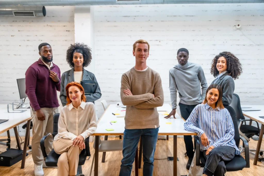 confident-man-standing-next-to-coworking-colleague-2024-12-10-03-07-58-utc